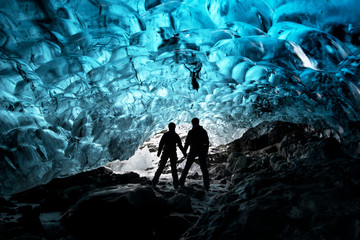 Silhouette of couple in ice cave