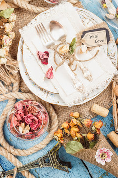 Tableware and silverware with different decorations on the table
