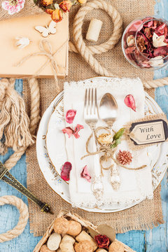 Tableware and silverware with different decorations on the table