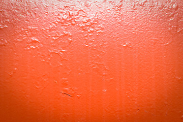 Painted red metal with dirt streaks