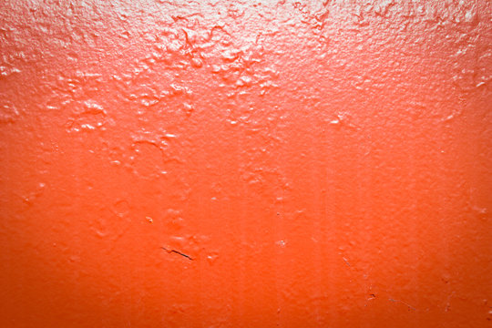 Painted red metal with dirt streaks