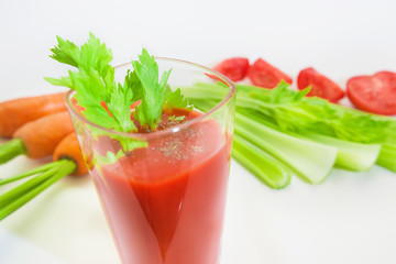 Glass of tomato juice with selery, pepper, carrot and tomatoes