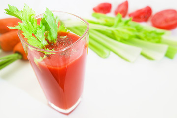 Glass of tomato juice with selery, pepper, carrot and tomatoes