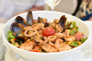 Mediterranean dish with calamari (squids), clams and tomatoes