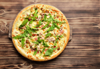 Hot big whole tasty pizza with melting cheese bacon tomatoes ham