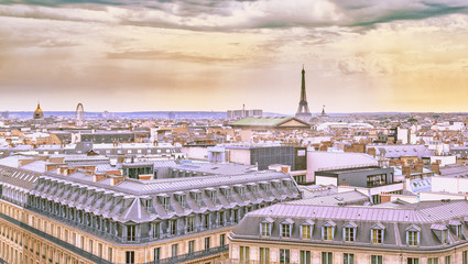 Fototapeta premium City landscape of Paris in pastel shades. Eiffel tower and old district near opera house at dramatic sky background. Summer sunny day scenery. France.