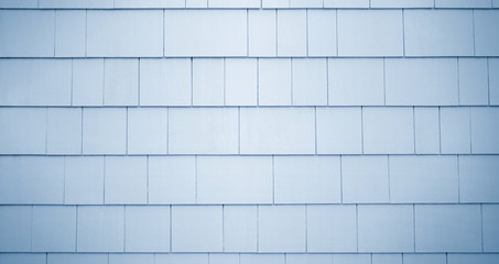 Neutral blue or gray siding on a house or building. Straight parallel lines. Outdoor siding with...
