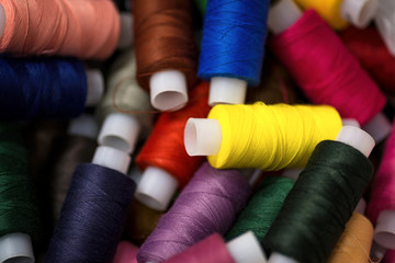 Many reels of threads for embroidery. Colorful macro background.