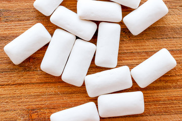 Chewing gum pieces on a wooden background