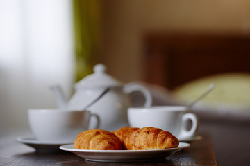 Завтрак с кофе и  круассанами в гостиничном номере
