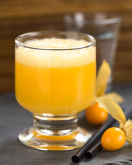 Peruvian cocktail called Aguaymanto Sour (Physalis Sour) made of physalis juice, pisco (Peruvian grape hard liquor), syrup and egg white(Selective Focus on the front of the glass rim and the froth)