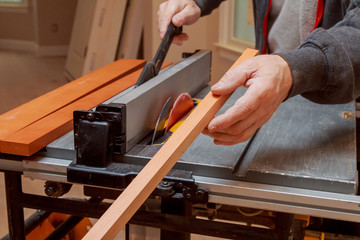 carpenter use ruler to measuring wood board