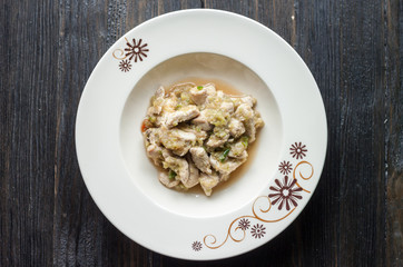 fried Chicken,chilli,Celery/.A plate placed on a round wooden ta