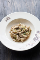 fried Chicken,chilli,Celery/.A plate placed on a round wooden ta