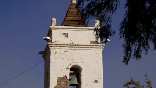 Old Church at Small village.  This one date from 1750 and is the most notable building in Toconao Village in Atacama/Chile. Close-up and Pan on the Church's tower.