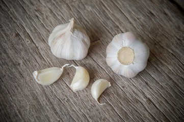 Garlic cloves on the old wooden table background