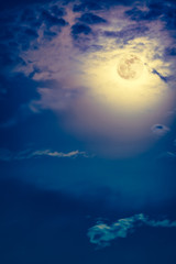 Fototapeta premium Nighttime sky with clouds and bright full moon with shiny.