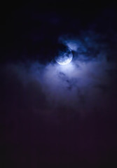 Nighttime sky with clouds and bright full moon with shiny.