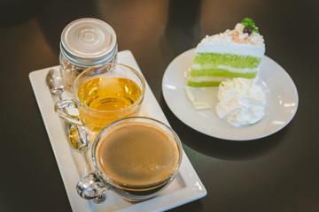 A cup of  coffee and a piece of cake.