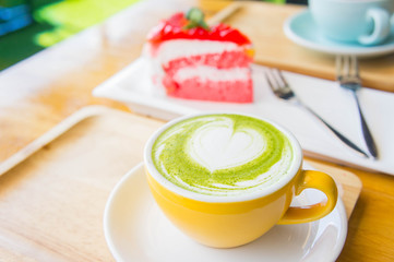hot green tea milk cup and coffee cup and strawberry cake