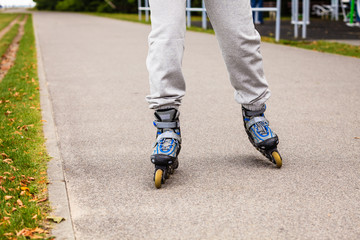 Human legs rollerblading wearing sportswear.
