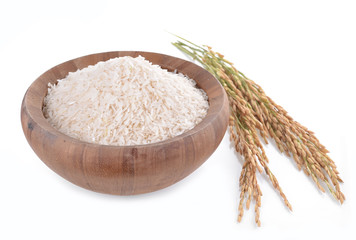 white rice on the wooden plate and rice plant , uncooked raw