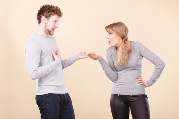 Young emotional couple arguing.