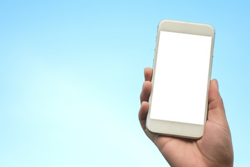 Mockup image of hand holding white mobile phone with blank white screen in blue sky background