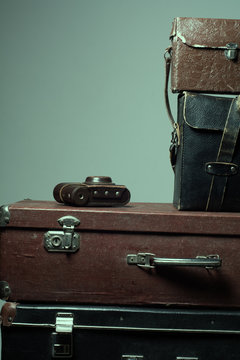 Background stack of old shabby suitcases and the camera