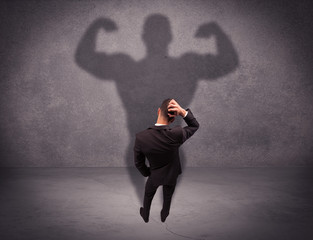 Successful businessman with strong shadow
