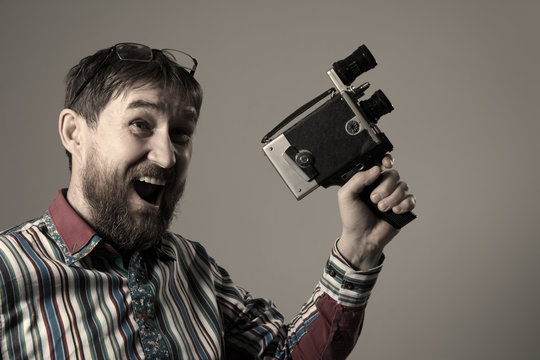 Happy bearded man old retro film camera