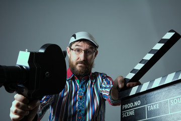Man Retro movie camera and clapperboard