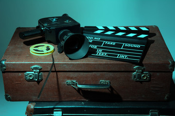 Old movie camera clapper and reel with film