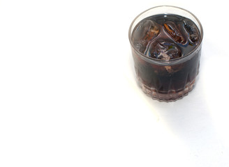 .coca cola mixed with ice in a glass. Placed on a white backgrou