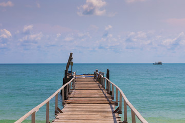 Wooden jetty leading to the seacoast, natural coastline landscape