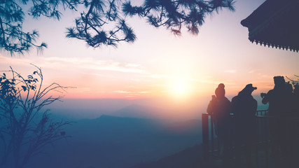 Tourists photograph the sunrise in the morning on the mountain.