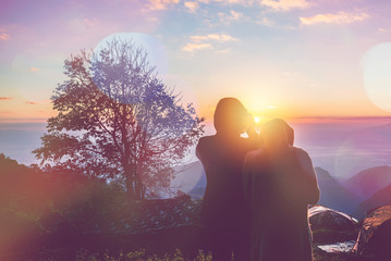 Tourists photograph the sunrise in the morning on the mountain.