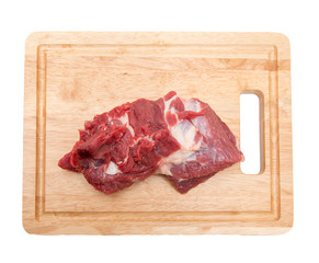 meat on a board on a white background