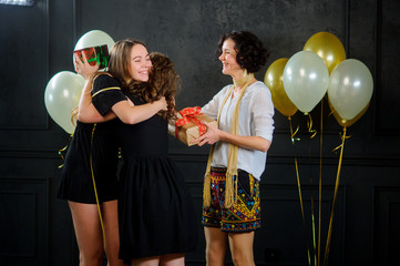 The girl receives congratulations and gifts from girlfriends.