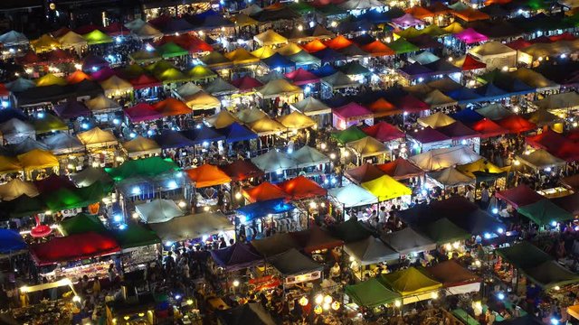 High view of colorful tent retail shop with night light at Talad Rod Fai Night Market, Ratchada, Bangkok, Thailand, 4k
