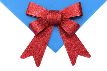 Bright red bow over white and blue background