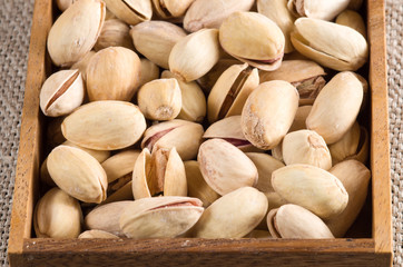 View close-up on pistachios in a wooden box