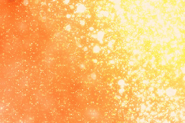 Golden sparkles or glitter lights. Festive gold background. Defocused circles bokeh or particles