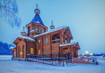 winter night landscape with old rural wooden Church with lightni