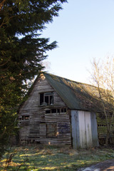 Old derelict empty wooden barn in country