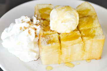 Honey toast with vanilla ice cream , whipped cream and syrup