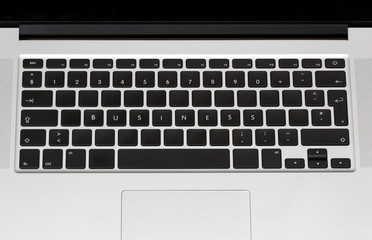 Business text written on a plain laptop keyboard. Business and internet concept image.