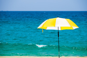 Beach umbrella on a sunny day against sea background.