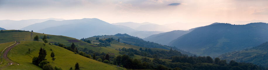Wide sunset panorama of the Carpathian mountains. Ukraine.