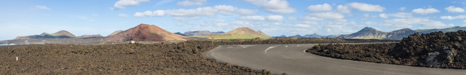 panoramic view of extinct volcanoes and a road through lava fields